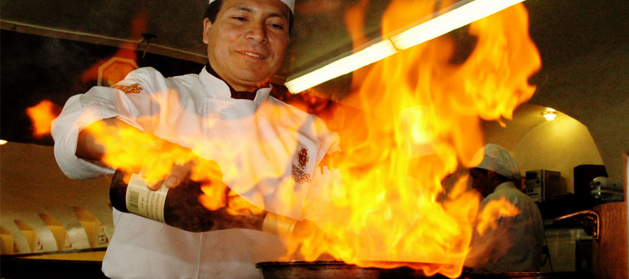 A Chef Flambeing with Wine