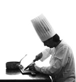 Chef Chopping Garlic in Culinary School